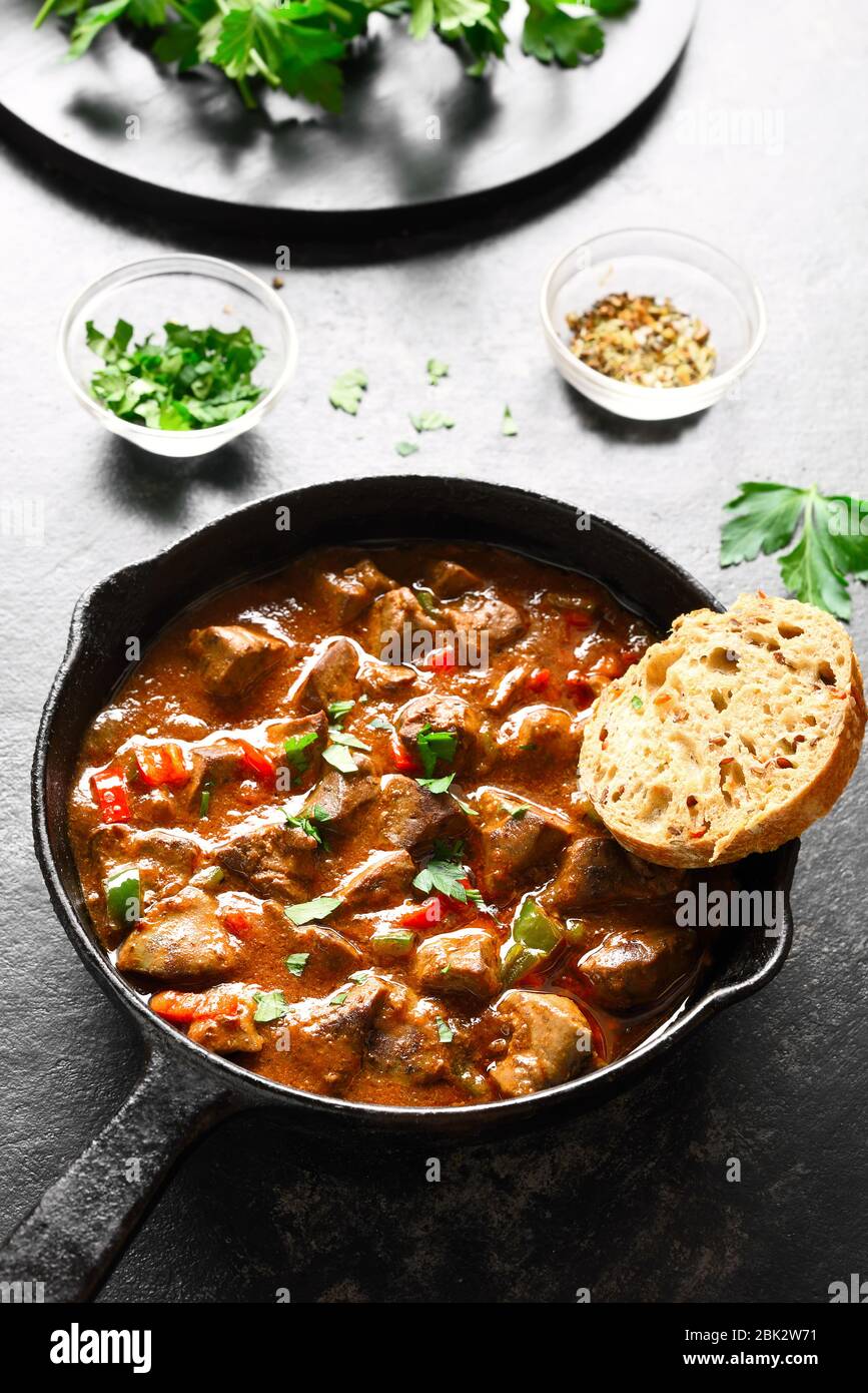 Periperi chicken livers in frying pan over dark stone background. Close up view Stock Photo Alamy