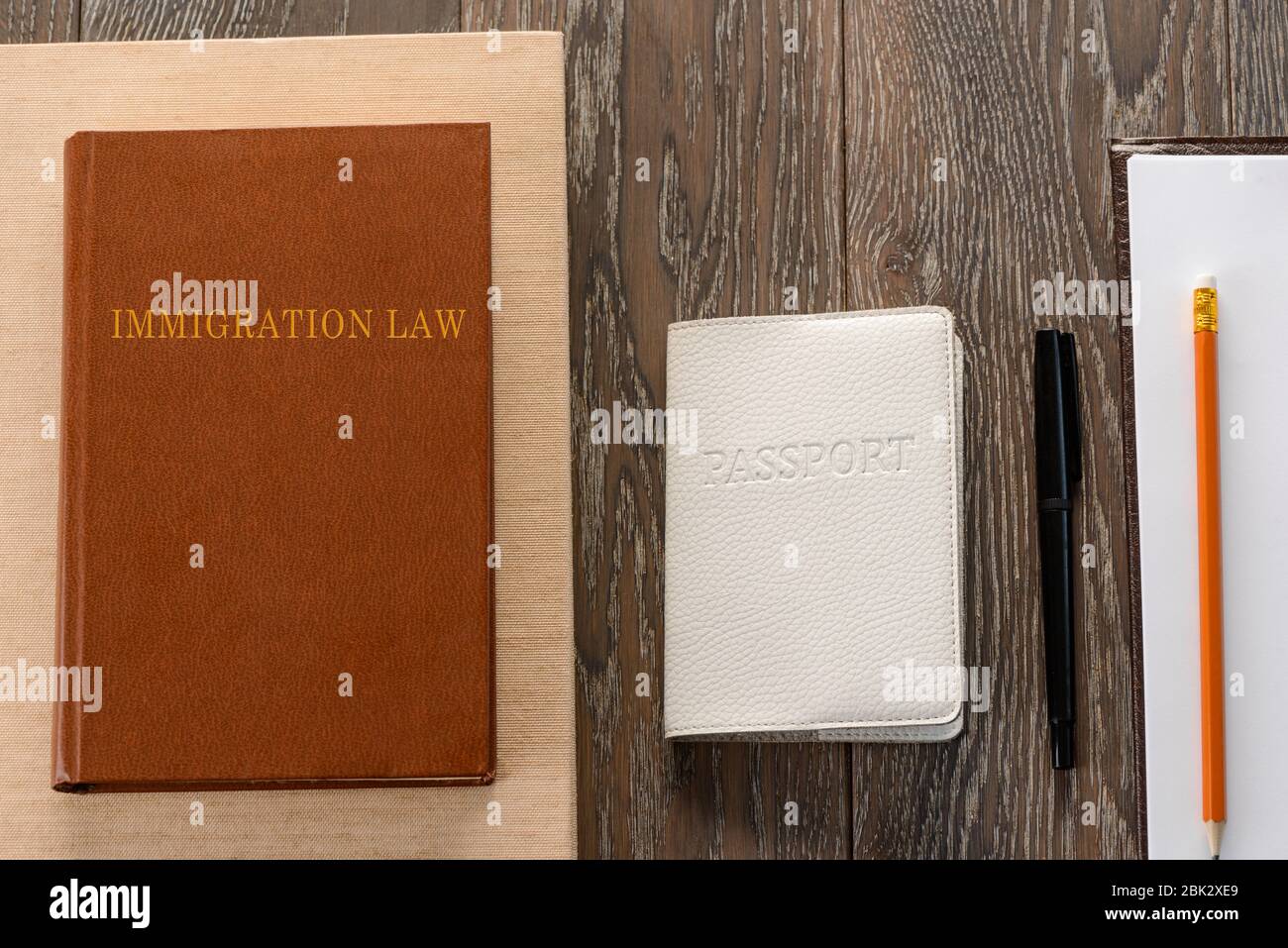 Passport, law book, application form and pen Stock Photo