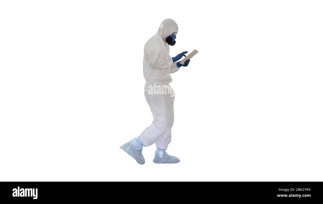 Scientist or docrot wearing biohazard suits and protective masks using digital tablet while walking on white background. Stock Photo