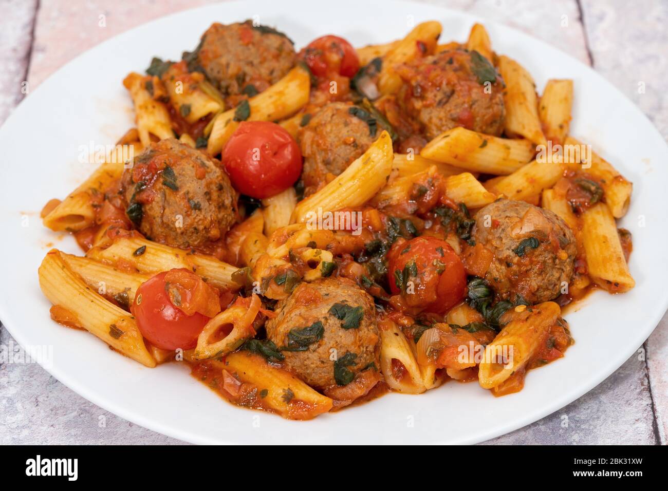Penne pasta with meatballs in tomato sauce Stock Photo - Alamy