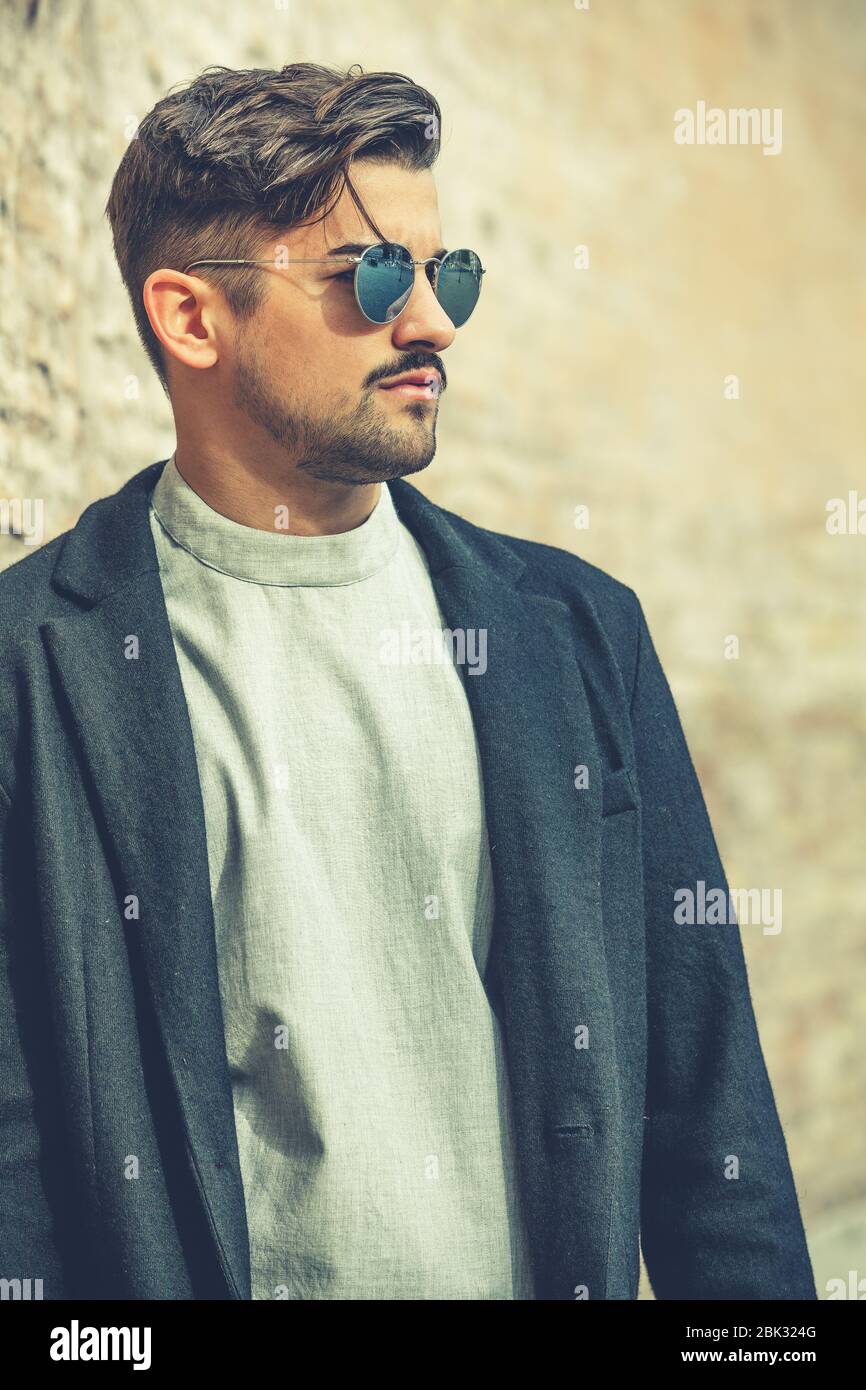 Handsome stylish man with sunglasses and modern hairstyle and beard. Outdoor in the street. White t-shirt and black jacket Stock Photo - Alamy Handsome stylish man with sunglasses and modern hairstyle and beard. Outdoor in the street. White t-shirt and black jacket Stock Photo - Alamy