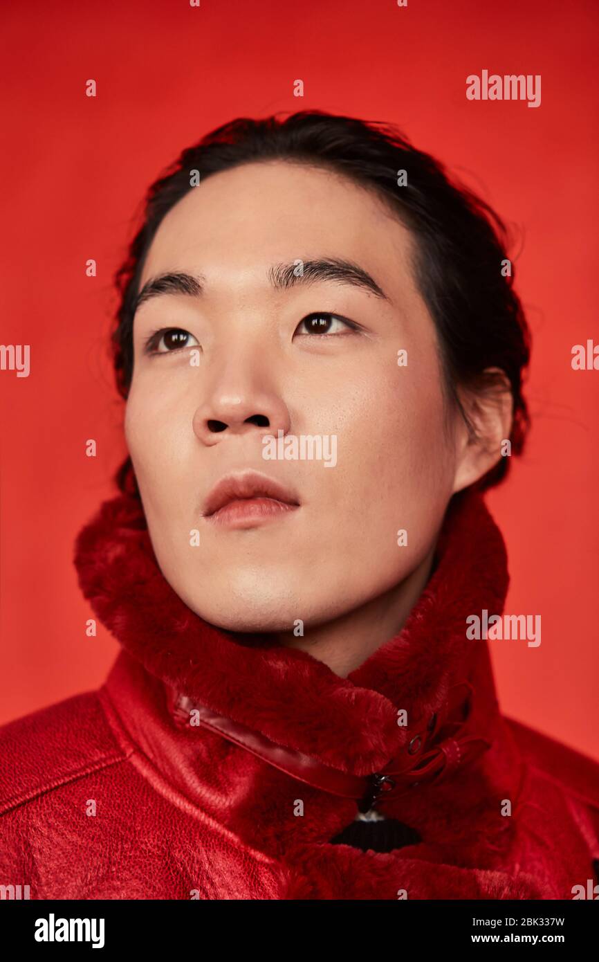 Asian man in red clothes on a red background Stock Photo