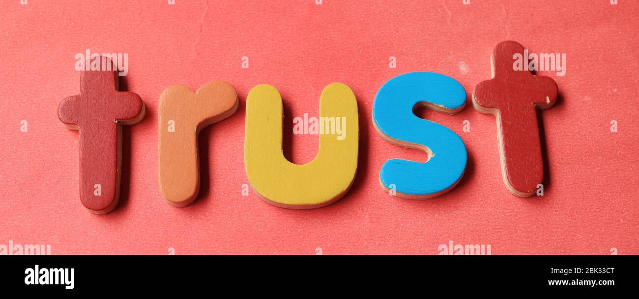 Trust word in business concept. Trust word written on red background in business concept. Stock Photo