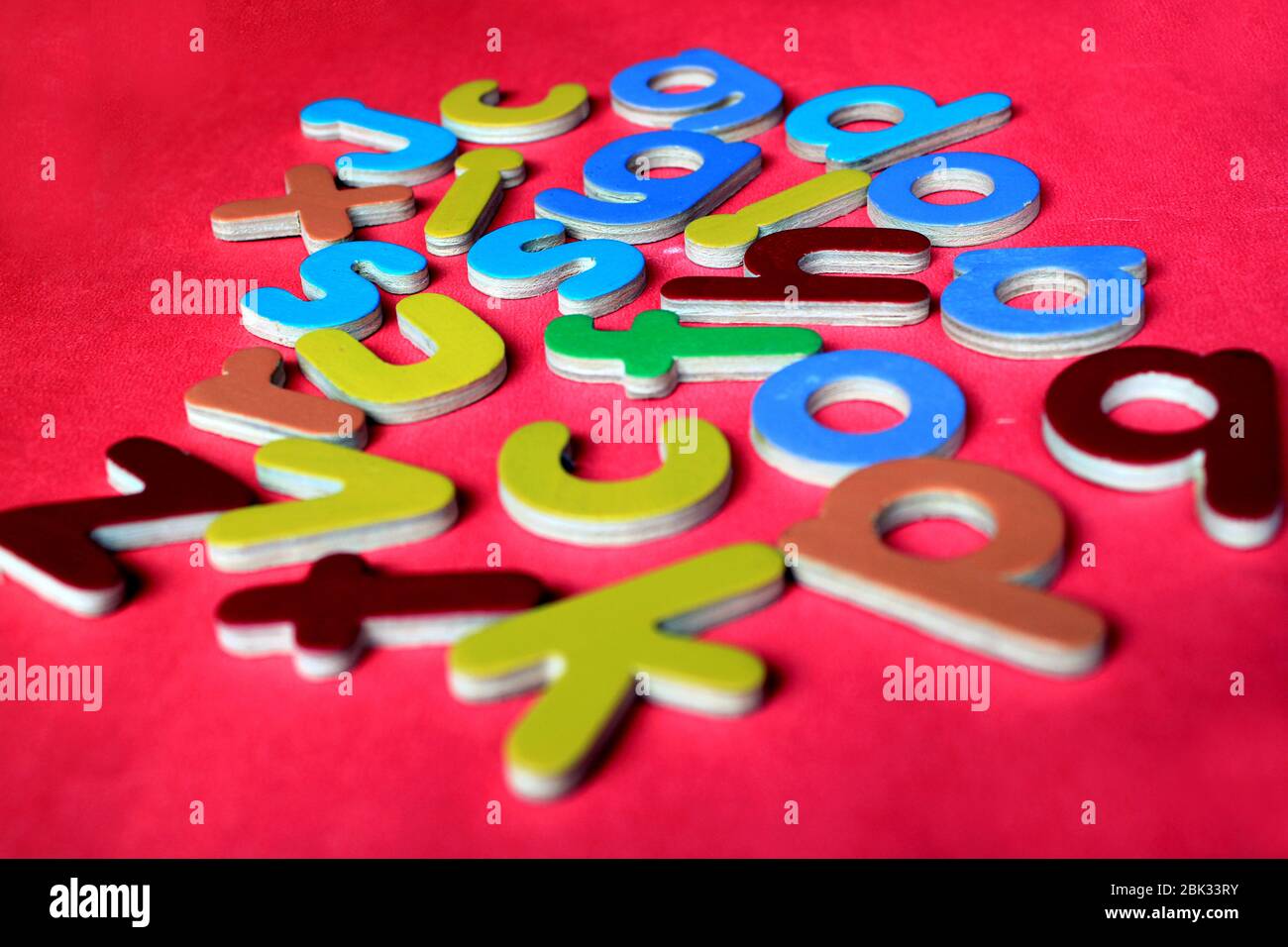 English Alphabets. Colorful wooden English small letters on a pink background. Stock Photo