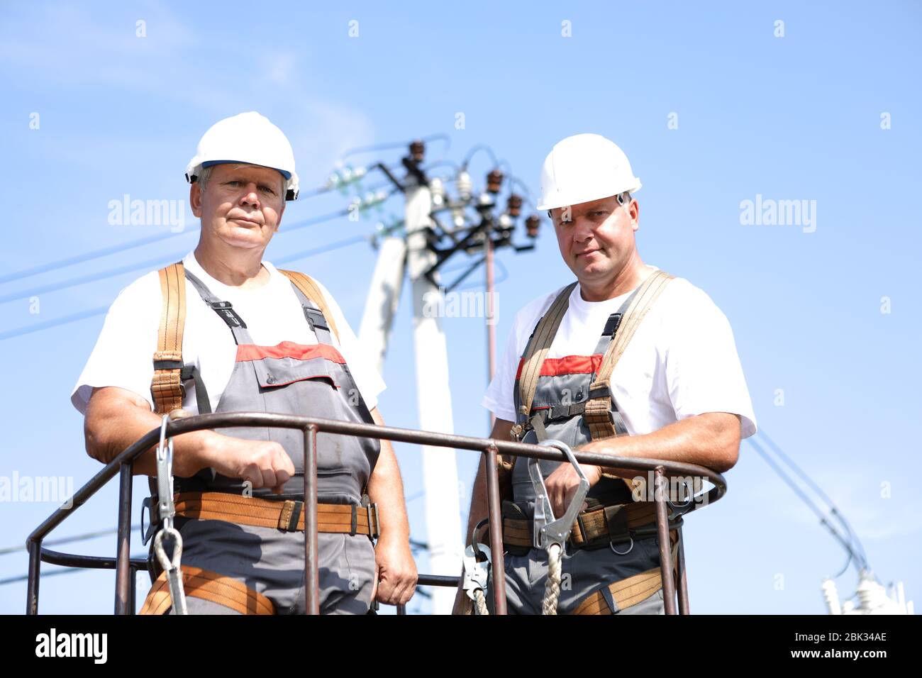 Electrical power lines workers hires stock photography and images Alamy