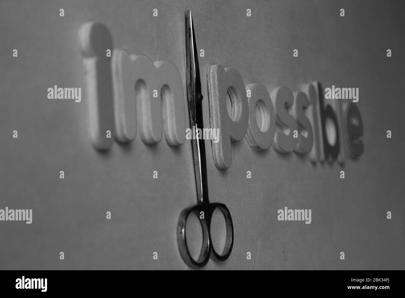 Self belief and positive concept, scissors cut off the word Impossible to read possible. From impossible to the possible. Stock Photo
