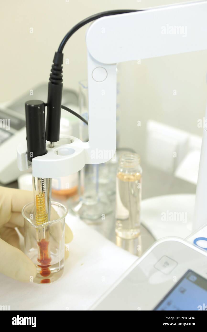 A chemist conducts a study of the stiffness of the solution. Laboratory PH measurement. A device for measuring PH chemically. Modern equipment for Stock Photo