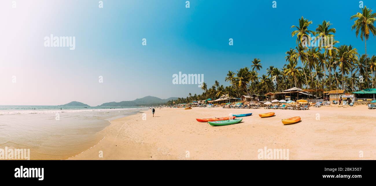 Canacona, Goa, India - February 16, 2020: Canoe Kayak For Rent Parked On Famous Palolem Beach On Background Tall Palm Tree In Summer Sunny Day. Stock Photo
