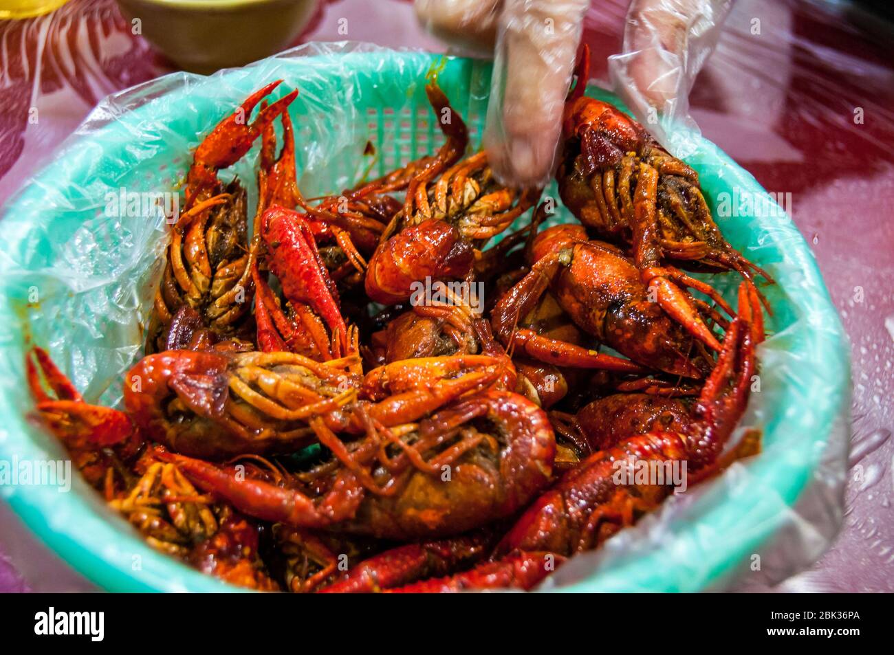 Eating mala flavoured crayfish (yabbies) in a restaruant on Shanghai's Shouning Road. Stock Photo