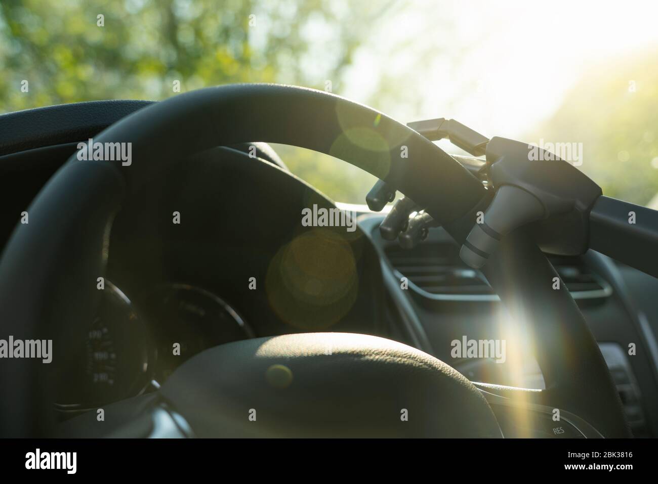 Robot arm on a steering wheel. Artificial intelligence drives a car. Autonomous vehicle concept. Stock Photo