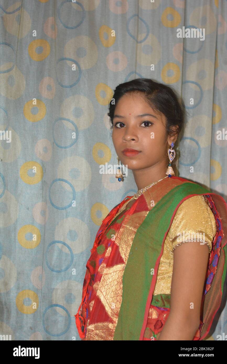 Close up of an beautiful Indian Girl wearing traditional big golden
