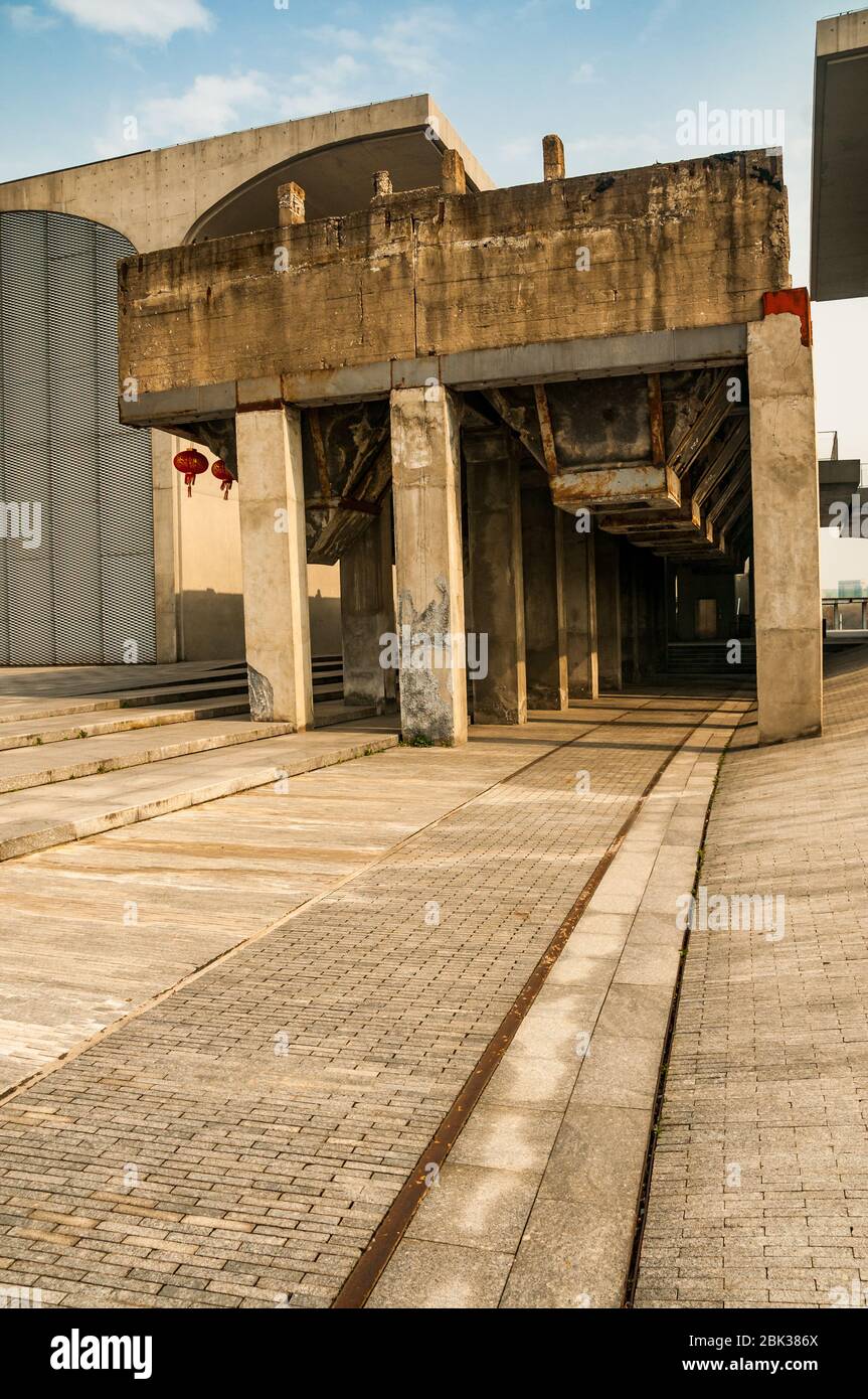 Old railway tracks leading to a preserved 1950s bridge for loading coal trucks surround by the industrial chic architecture of the Long Museum West Bu Stock Photo