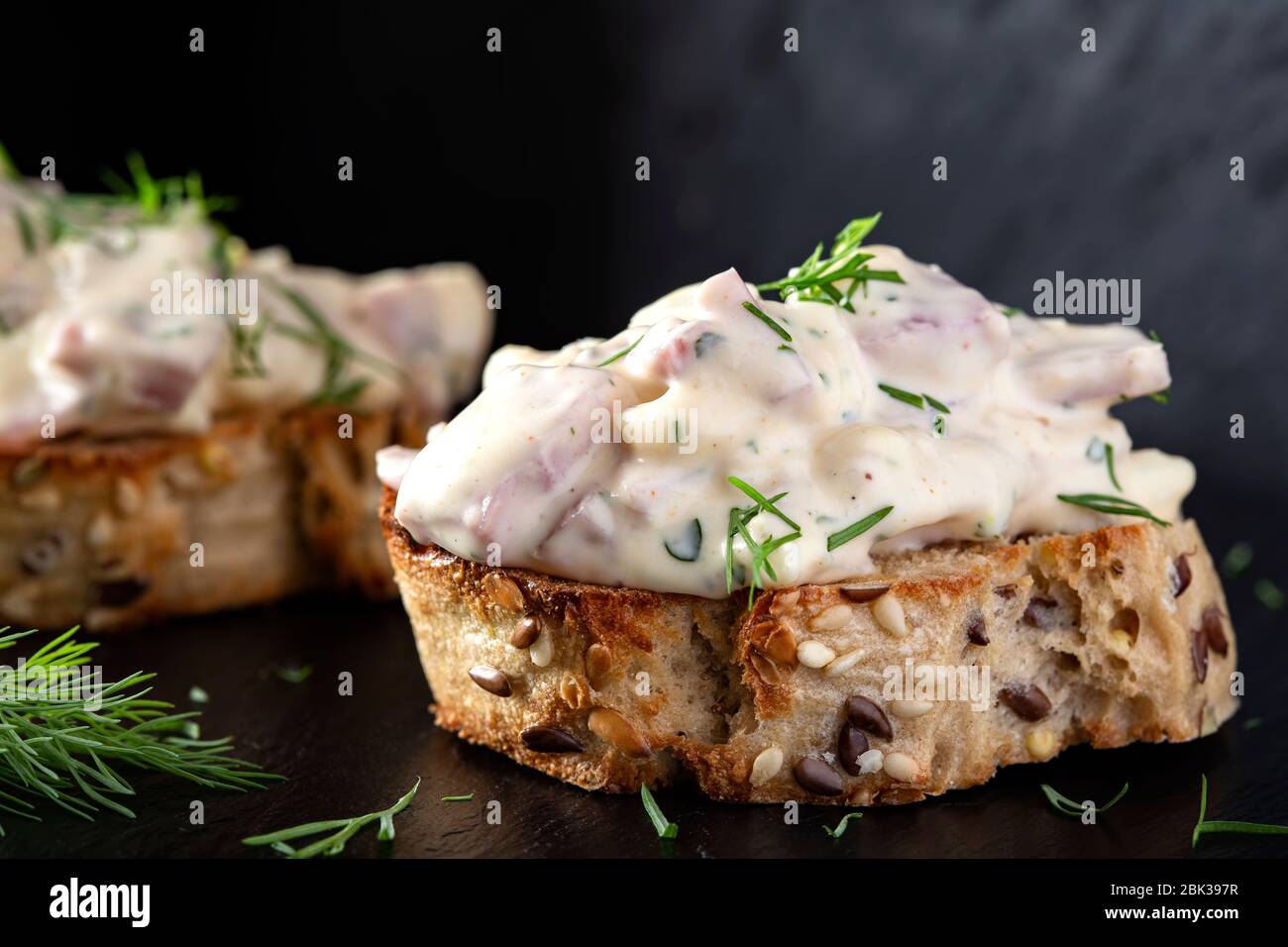 Appetizer with salad made from meat, mayonnaise and asparagus on bread Stock Photo