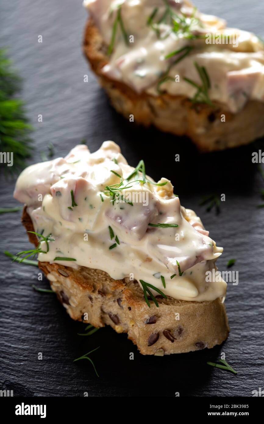 Appetizer with salad made from meat, mayonnaise and asparagus on bread Stock Photo