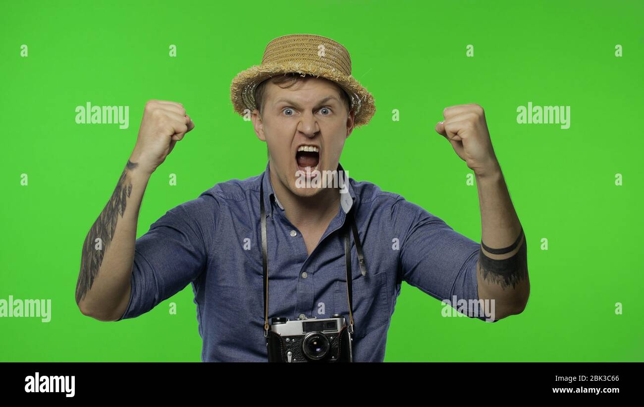 Portrait of man fashion tourist photographer looking displeased and ...
