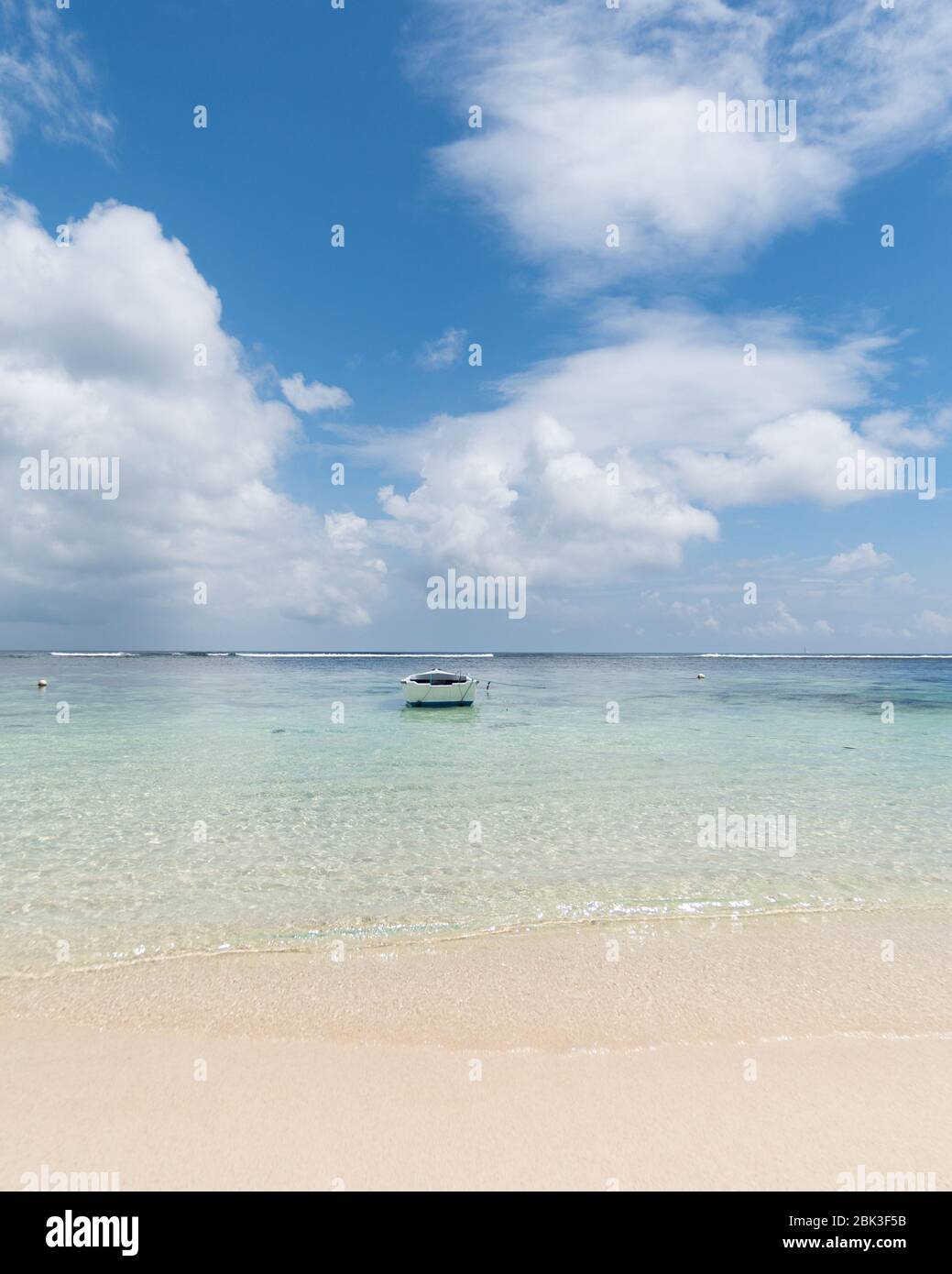 Small rowing boat on the Beach in Seychelles, Mahe Island Indian Ocean.  A picture of peace and relaxation on the east coast of Mahe island. Stock Photo