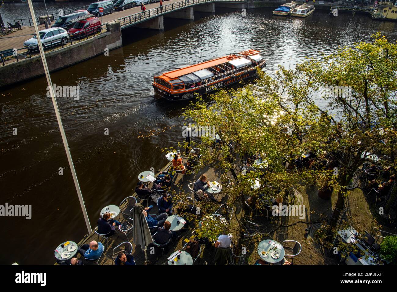 Patrons at outdoor tables on patio of de Jaren cafe, Amsterdam, North Holland, Netherlands Stock Photo