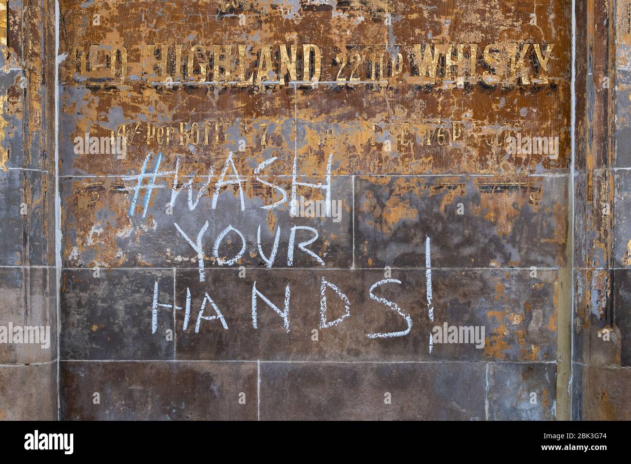 Wash Your Hands chalked on wall in Partick, Scotland, UK during coronavirus outbreak Stock Photo