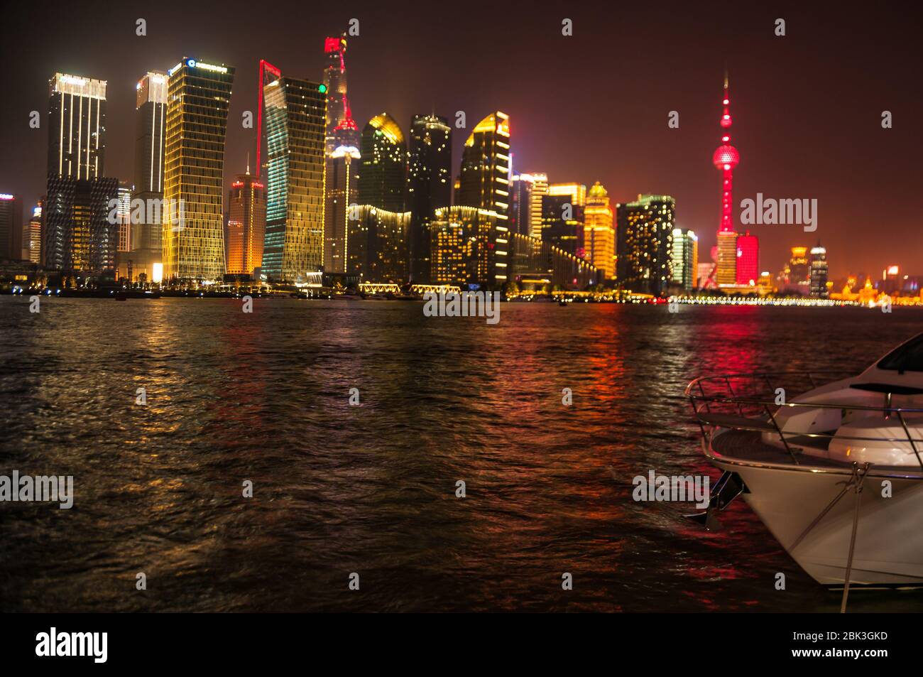The illuminated Pudong skyline seen behind Xin Da Tang, a yacht moored on the North Bund part of Shanghai. Stock Photo