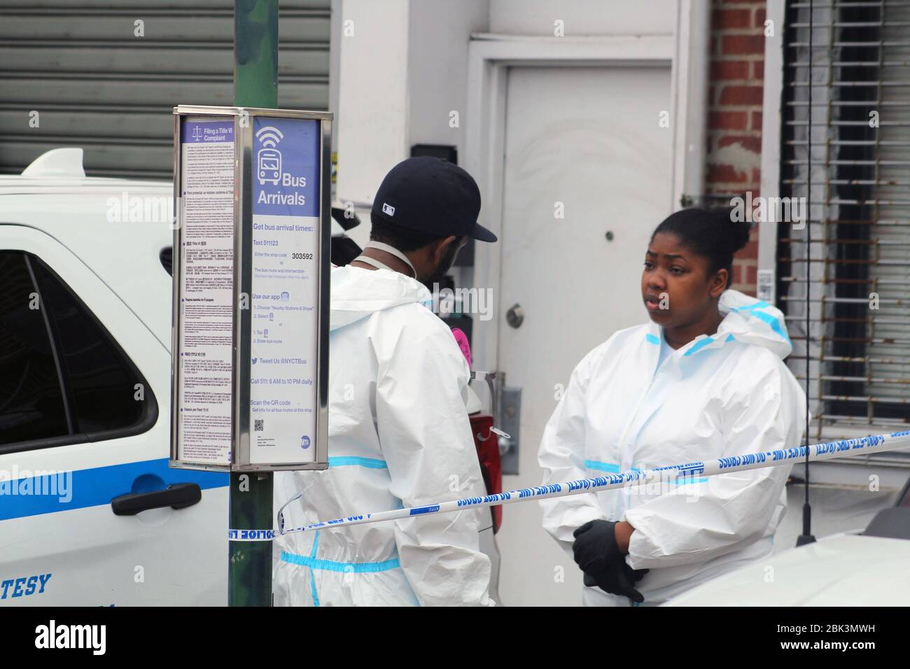 New York, New York, USA. 30th Apr, 2020. Two workers talk, both wearing a hazmat, next to the Andrew T. Cleckley Funeral Home in Brooklyn where bodies that weren't properly cared have been removed. 60 corpses were stored in 4 non-refregerated trucks lining the street along the stores. New York authorities showed up after neighbors reported a foul smell and fluids dripping from the trucks. Some bodies were also found lying on the facilityÃ¢â‚¬â„¢s floor. Credit: Marie Le Ble/ZUMA Wire/Alamy Live News Stock Photo