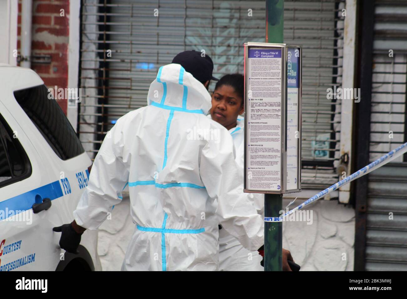 New York, New York, USA. 30th Apr, 2020. A worker addresses his colleague, both wearing a hazmat, next to the Andrew T. Cleckley Funeral Home in Brooklyn where bodies that weren't properly cared have been removed. 60 corpses were stored in 4 non-refregerated trucks lining the street along the stores. New York authorities showed up after neighbors reported a foul smell and fluids dripping from the trucks. Some bodies were also found lying on the facility's floor. Credit: Marie Le Ble/ZUMA Wire/Alamy Live News Stock Photo