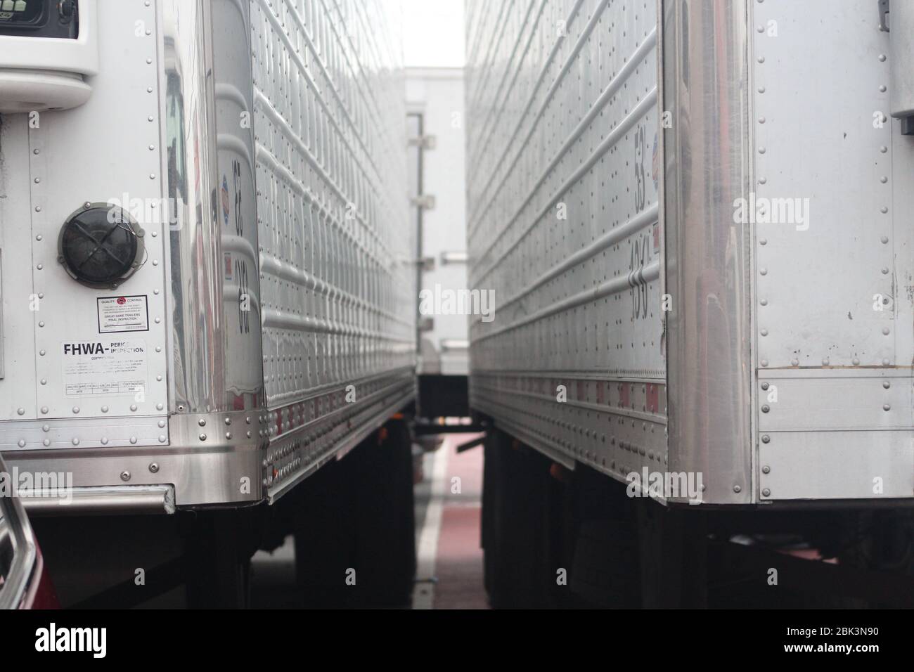 New York, New York, USA. 30th Apr, 2020. Six trucks, including two large refrigerated ones, block part of the street near the Andrew T. Cleckley Funeral Home in Brooklyn where bodies non properly cared have been removed. 60 bodies were stored in 4 non-refregerated vehiciles lining the street nearby stores. Neighbors reported a foul smell still persistent and fluids dripping from the trucks. Some remains were also found lying on the facilityÃ¢â‚¬â„¢s floor. The funeral home was overwhelmed by COVID-19 deaths in New York. Credit: Marie Le Ble/ZUMA Wire/Alamy Live News Stock Photo