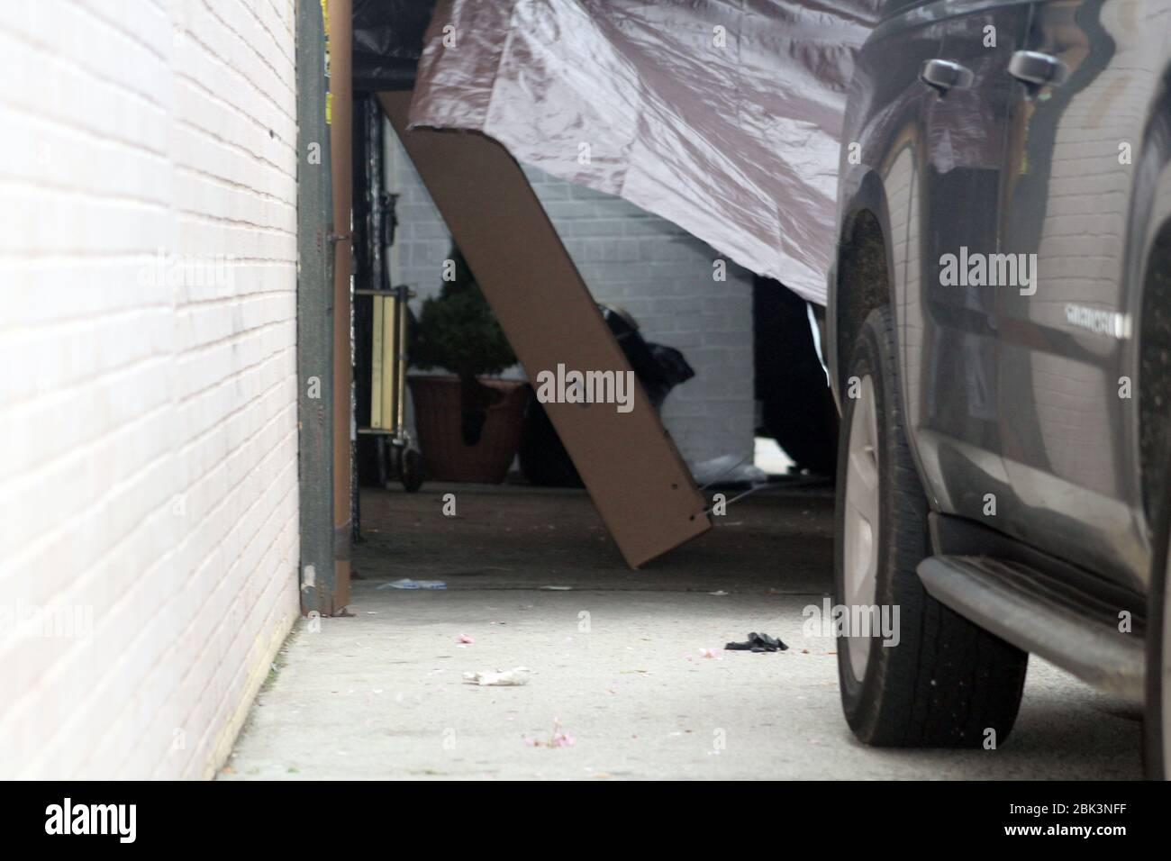 New York, New York, USA. 30th Apr, 2020. A cardboard coffin has been placed upright against a wall near a hearse in the Andrew T. Cleckley Funeral Home in Brooklyn where bodies not properly cared are removed. 60 corpses were stored in 4 non-refrigerated trucks lining the street along stores. Neighbors reported a foul smell and fluids dripping from the trucks. Some remains were also found lying on the facilityÃ¢â‚¬â„¢s floor. In New York City alone, there have been almost 13,000 COVID-19 deaths. Credit: Marie Le Ble/ZUMA Wire/Alamy Live News Stock Photo