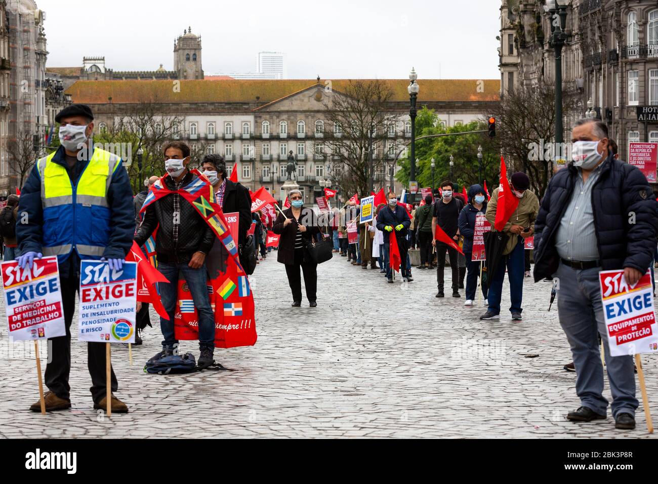 A people stages a silent protest while practicing social distancing to mark Labor Day in Porto, Portugal. Workers were forced to scale back the rallies around the world on May 1, 2020, because of coronavirus lockdowns, although some pushed on with online events and others hit the streets in face masks. Stock Photo