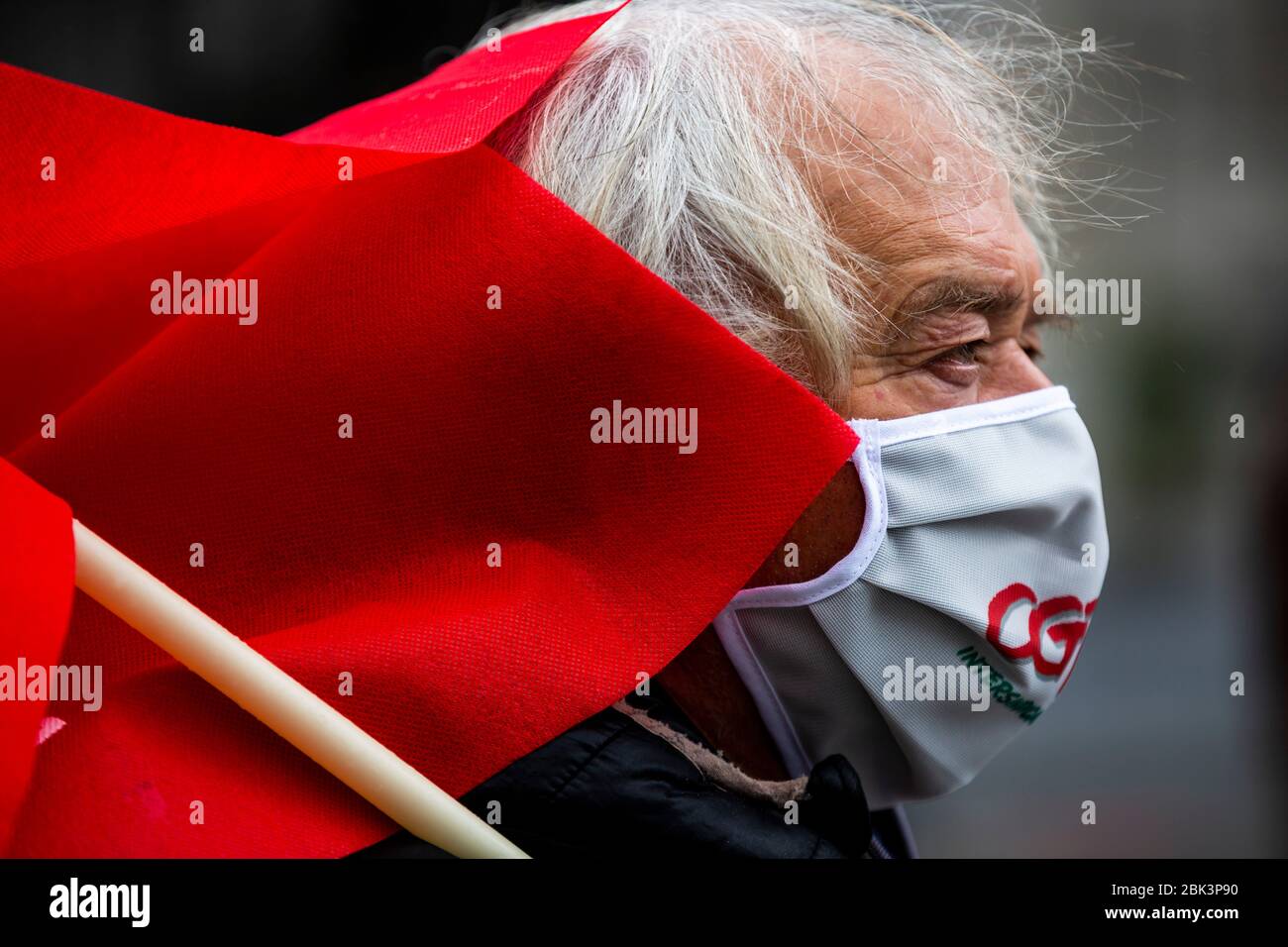 A man stage a silent protest while practicing social distancing to mark Labor Day in Porto, Portugal. Workers were forced to scale back May Day rallies around the world on May 1, 2020, because of coronavirus lockdowns, although some pushed on with online events and others hit the streets in face masks. Stock Photo