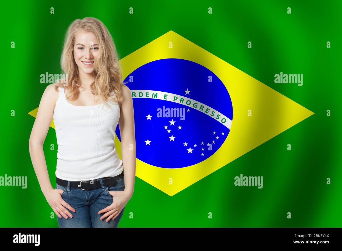 Happy cute girl with the Brazil flag background Stock Photo - Alamy
