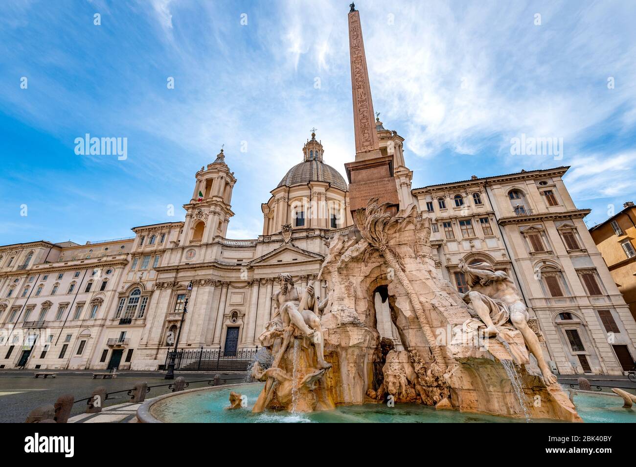 Rome, Italy. 30th Apr, 2020. A view of the fountain of four rivers by Gian Lorenzo Bernini in front of Sant'Agnese church by Francesco Borromini in an and almost desert Navona square during Italy's lockdown due to Covid-19 pandemic. On May 4th will start the phase 2 of the measures against pandemic, adopted by Italian government, that will allow some construction and factory workers to go back to work . Credit: insidefoto srl/Alamy Live News Stock Photo