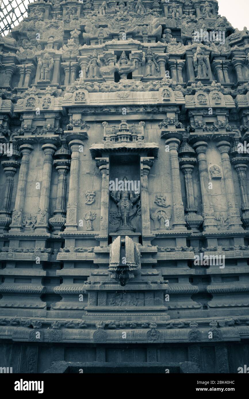 A monochrome picture of Hindu idol in a temple wall in  South India Stock Photo