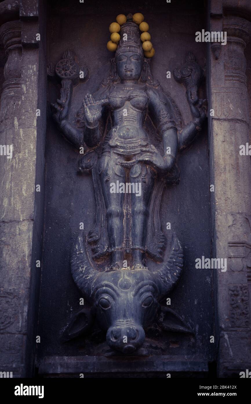 A beautiful Hindu idol carved on the wall of a temple in India Stock Photo