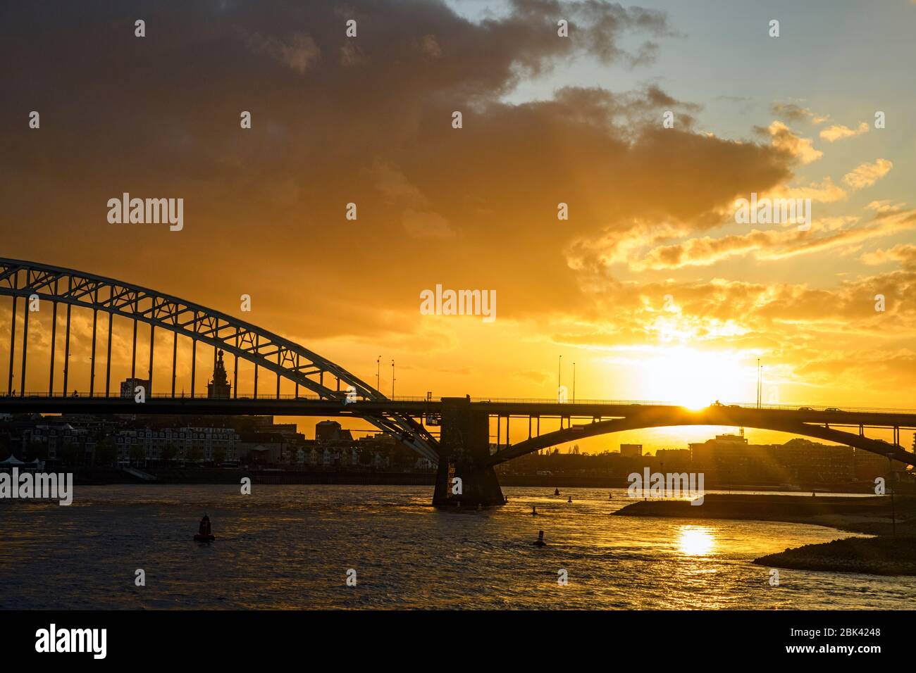 Waalbrug Bridge over the Waal River at sunset, Nijmegen, Gelderland, Netherlands Stock Photo