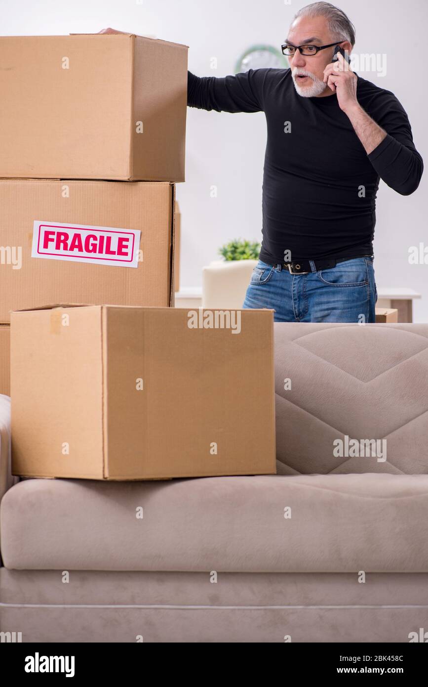 Old professional mover doing home relocation Stock Photo