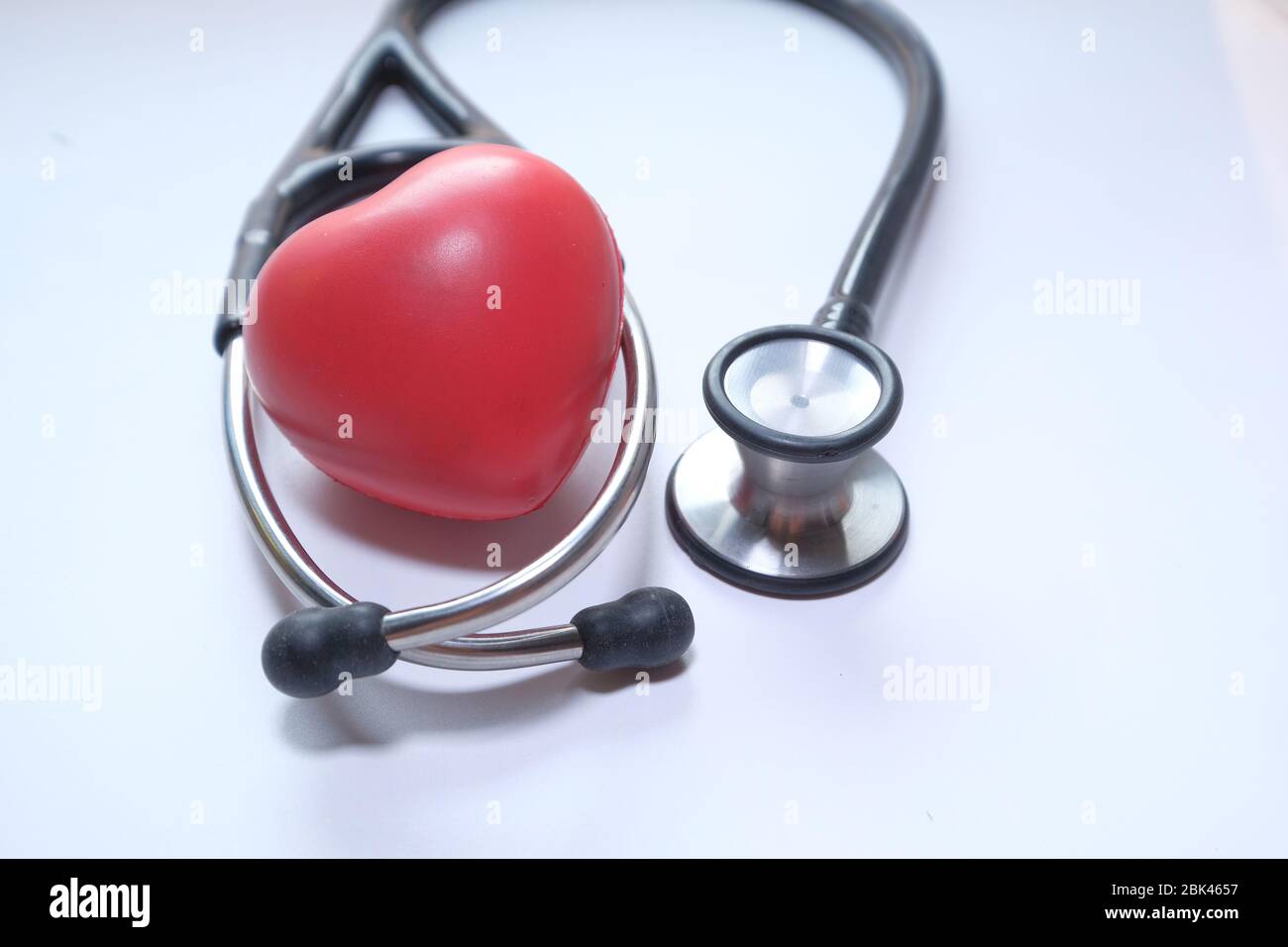 Stethoscope and heart on white background, Close up. Stock Photo
