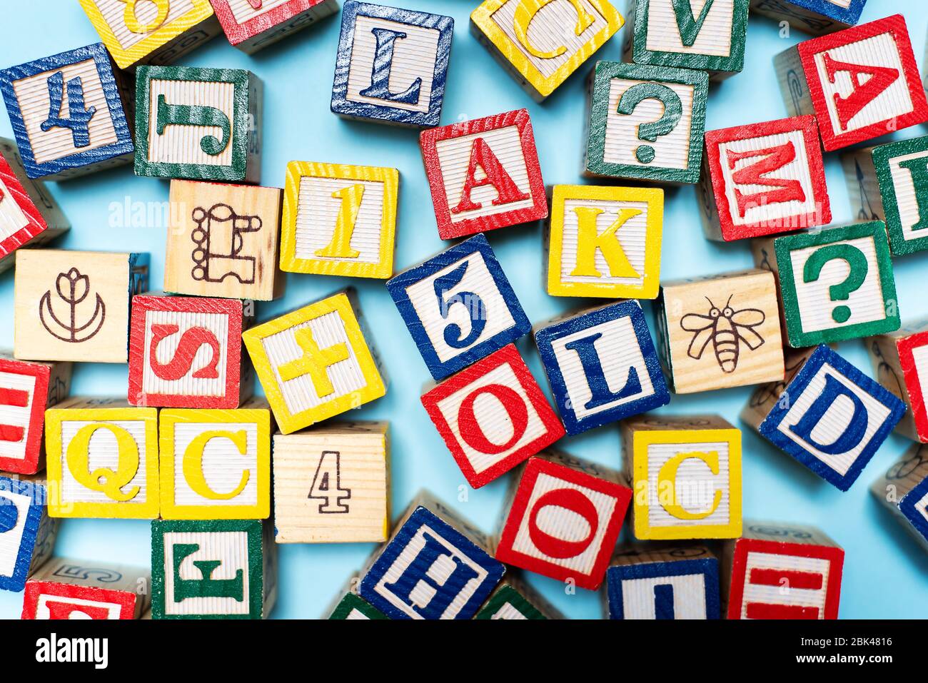 Alphabet characters written with wooden letters, education abstract background top view Stock Photo