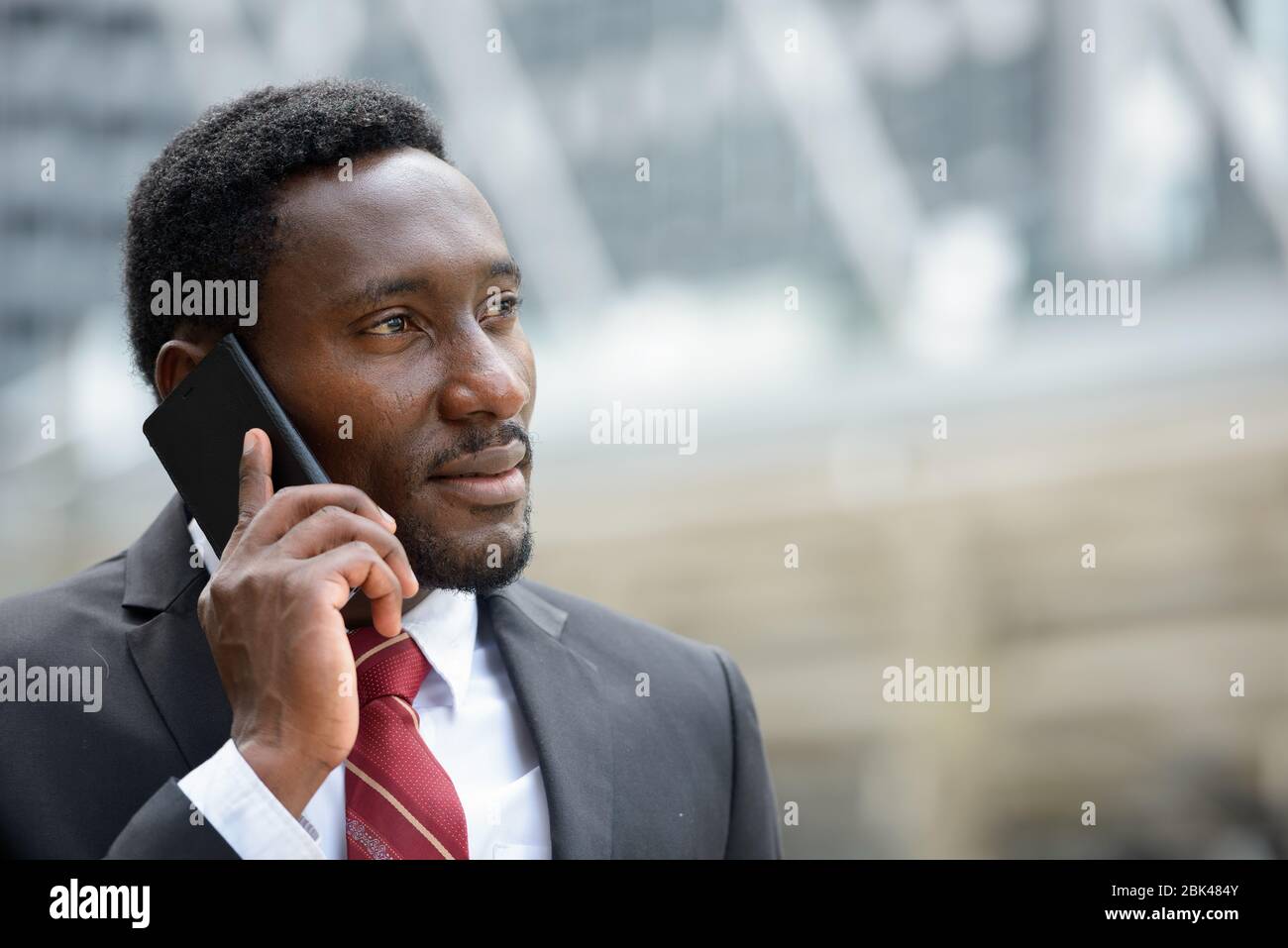 Young handsome African businessman talking on mobile phone Stock Photo