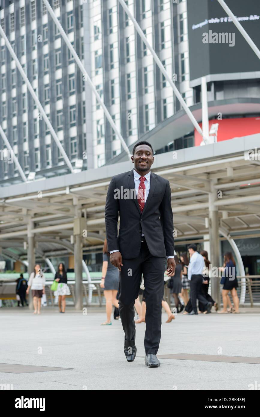 Men in black suit walking hi-res stock photography and images - Alamy