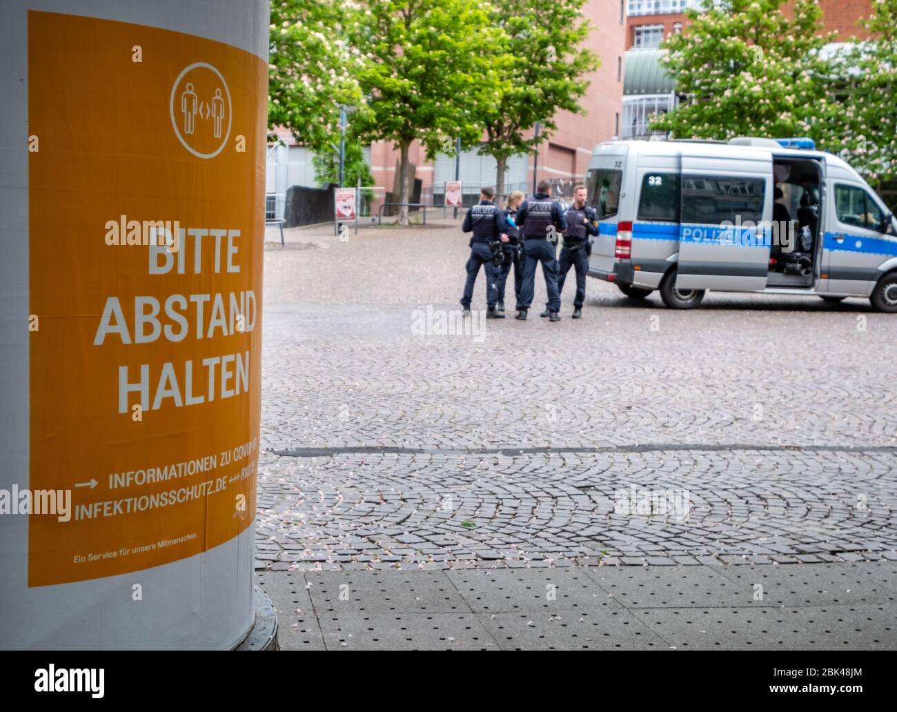 Deutschland. 01st May, 2020. Police control the city center of Karlsruhe, on the left a poster with the words 'Please keep your distance' GES/Daily life in (Karlsruhe) during the corona crisis, 01.05.2020 GES/Daily life during the corona crisis in Karlsruhe, Germany. 01.05.2020 | usage worldwide Credit: dpa/Alamy Live News Stock Photo