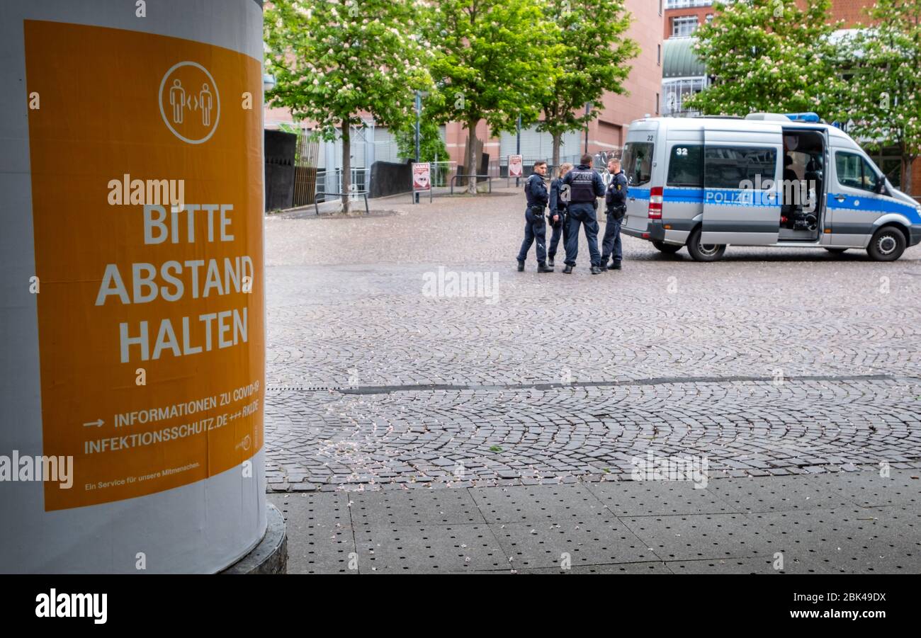 Deutschland. 01st May, 2020. Police control the city center of Karlsruhe, on the left a poster with the words 'Please keep your distance' GES/Daily life in (Karlsruhe) during the corona crisis, 01.05.2020 GES/Daily life during the corona crisis in Karlsruhe, Germany. 01.05.2020 | usage worldwide Credit: dpa/Alamy Live News Stock Photo