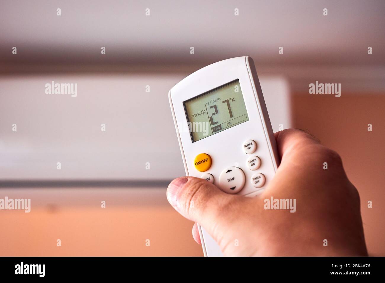 Split Air conditioner, Man operating remote controller Stock Photo Alamy