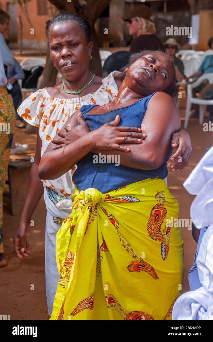 A woman is dancing and falling into a trance during a Voodoo, or vodu, ceremony in Lome, the