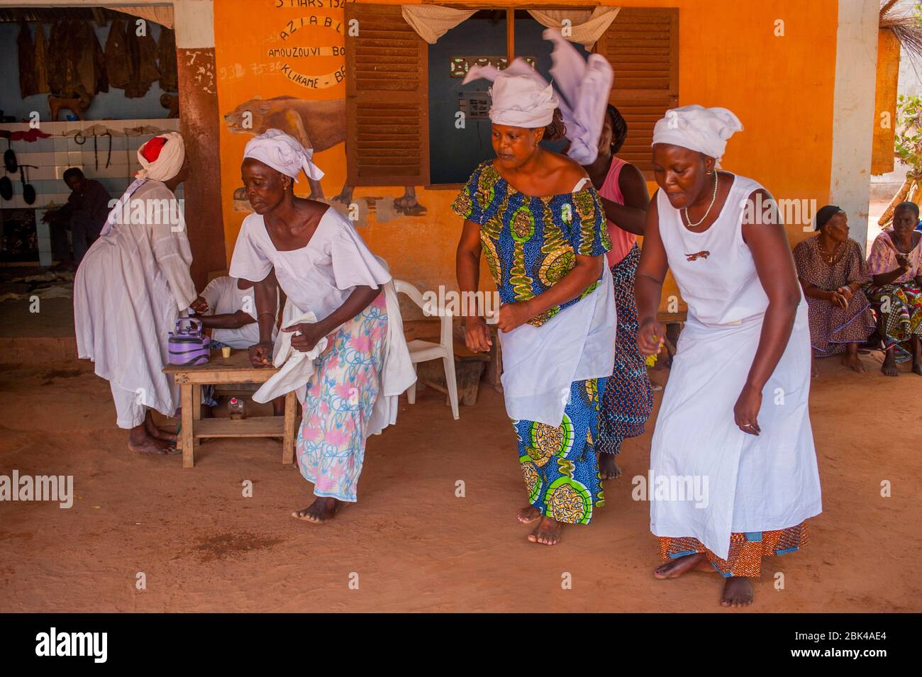 Women are dancing to fall into a trance during a Voodoo, or vodu, ceremony in Lome, the capital