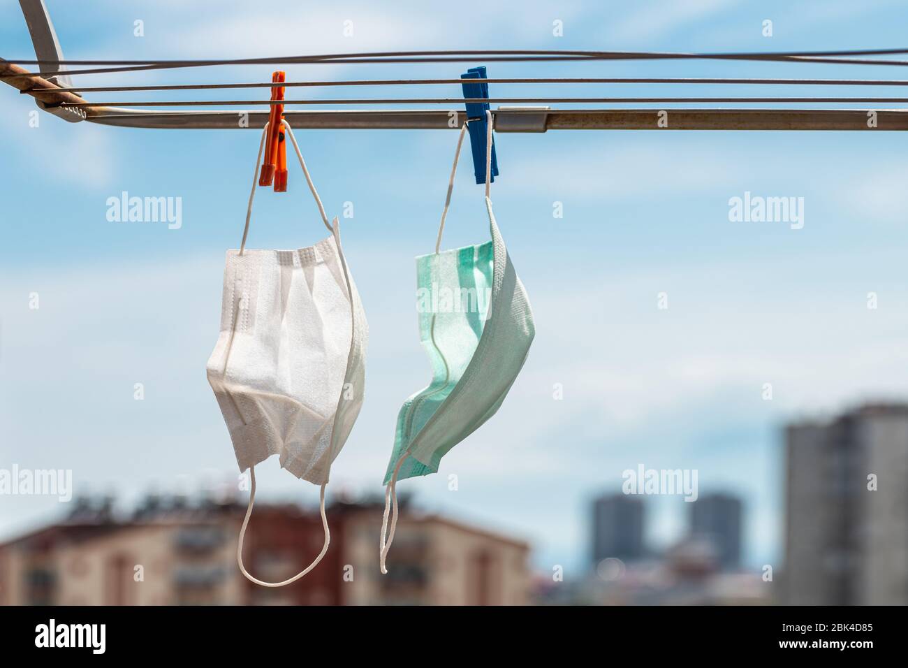 Protective Medical mask hung on the clothes line during Covid-19 coronavirus pandemic quarantine Stock Photo