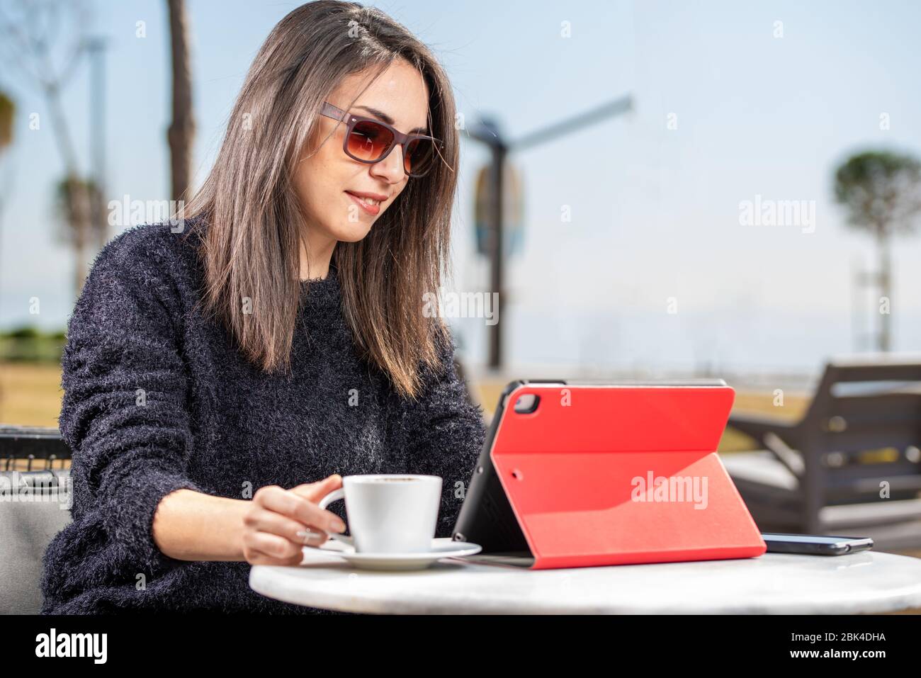 Beautiful young woman having Zoom video conference call via tablet