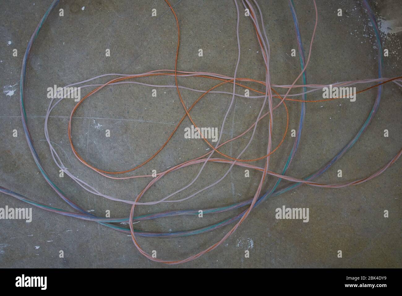 Cable power cords in a tangled mess on floor workplace.Electric wire on