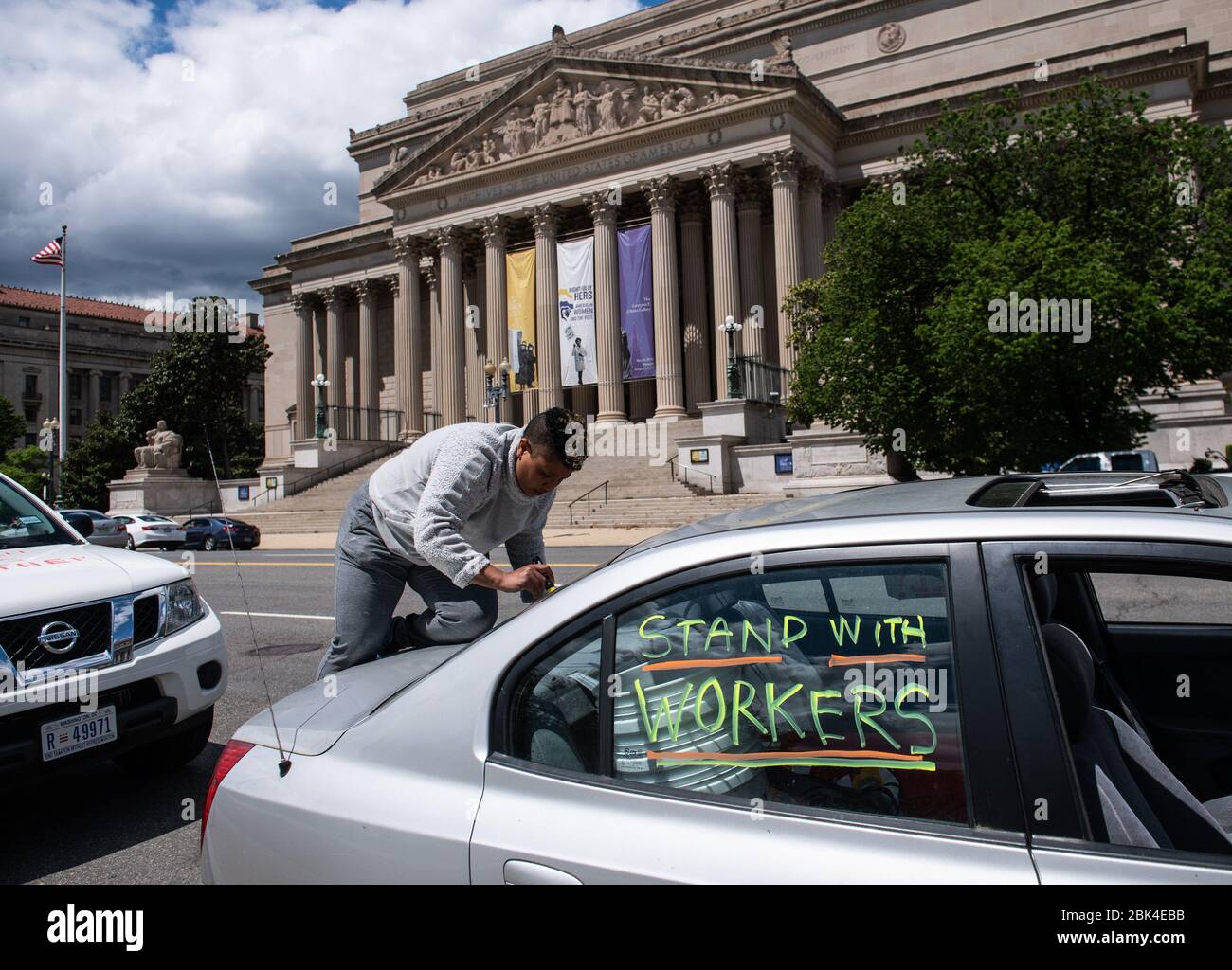 Washington, United States. 01st May, 2020. An activist decorates their car prior to a vehicle protest for workers rights during the Coronavirus pandemic near the National Mall in Washington, DC on Friday, May 1, 2020. The group ShutdownDC is holding a rally for support of front line workers and asking the DC to stay 'closed' and not rush to open the economy in the wake of the COVID-19 pandemic. Photo by Kevin Dietsch/UPI Credit: UPI/Alamy Live News Stock Photo