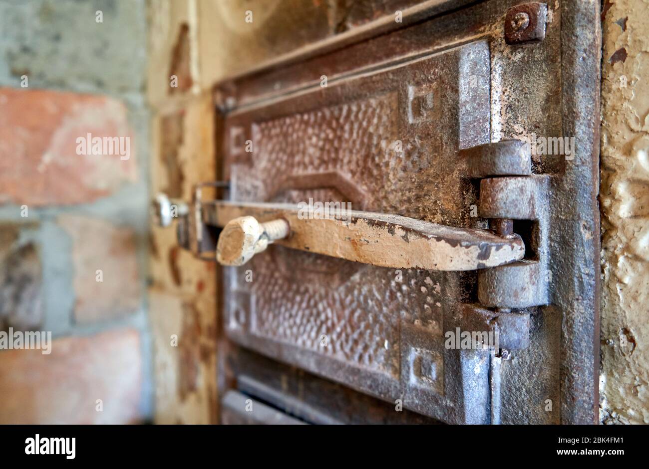 Metal door with a tick for the old tiled stove Stock Photo