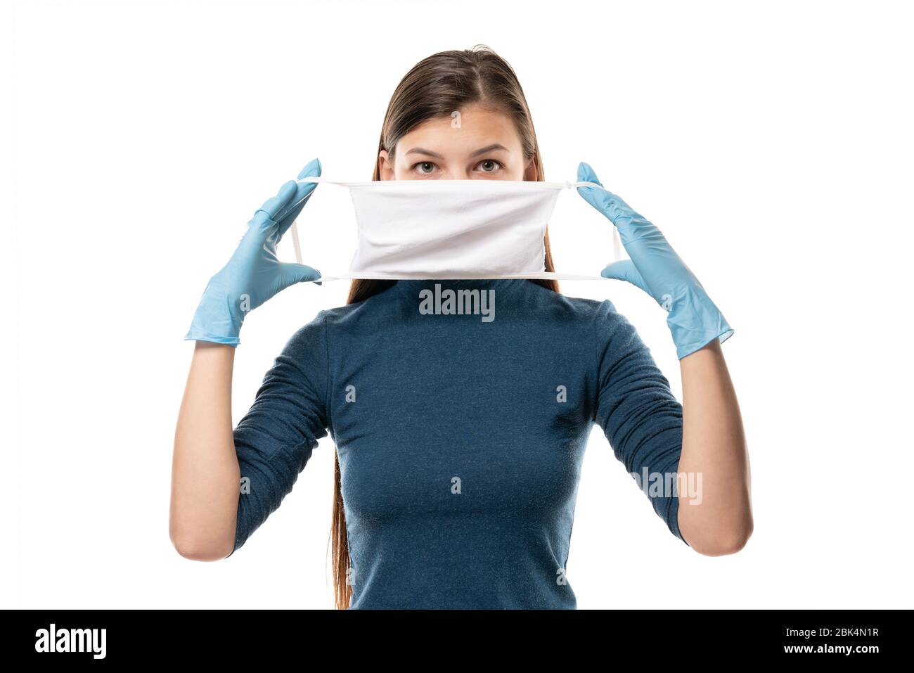 Young woman patient in a medical gloves puts on protective surgical ...